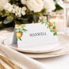 April citrus wedding placecard on a plate at a reception table setting