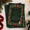 Bird Wreath Christmas invitation on a deep green envelope with red velvet ribbon and pine sprigs