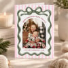 Merry Little Christmas Cards Folded standing on a table with a candle and Christmas greenery