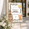 Cheers & Beers Birthday Party Welcome Sign on a gold easel beside white flowers