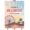 Festival Party Welcome Sign with a ferris wheel and palm trees at sunset on a timber easel
